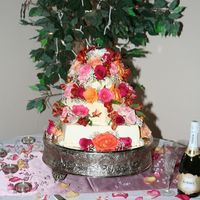 Kristin & Zack Two square layers with hexagon top layer with fresh flowers as decoration.