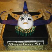 Mardi Gras 60Th Birthday French vanilla 14" square, dark chocolate raspberry ganache filling, black Satin Ice fondant . Pastillage mask, neck ruffle and hat,...