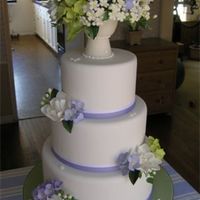 Wedding Cake With Sugar Vase Stacked fondant covered cakes with grosgrain ribbon at bases. Decorated with a sugar vase filled with gumpaste gardenias, peonies,...
