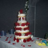 My First Wedding Cake Made with fondant, gold luster dust and fresh roses. Grooms cake is a fishing theme.