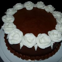 Wilton Class Cake Chocolate frosting with white buttercream roses. I didn't want to do the traditional rose spray so this is what Icame up with.