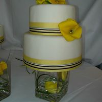 Round Wedding Cake With Yellow Callas For my SIL's wedding cake. This is a cheesecake covered with fondant. It is a 6" and 8" cake. The cheesecakes were 3 inches...