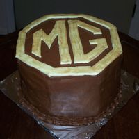 Mg Buttercream with fondant accents. This was made for a MG car club annual party.