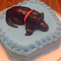 Dachsund Puppy This is a dashund puppy lieing down. I made this out of RKT covered with fondant. This was my first attempt at an animal.