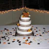 Wedding Cake This was a raspberry-filled white cake. Buttercream frosting, brown ribbon trim, and fresh flowers.