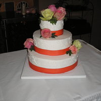 Wedding Cake This was a raspberry filled white cake. Orange ribbon trim with fresh roses.