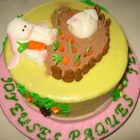Bunny's Carrots Chocolate cake, caramel frosting and filling. Rolled fondant.Rabbits and carrots made out of fondant with a little CMC. Chocolate powder.