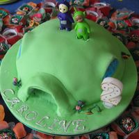 Teletubbies All fondant, except the teletubbies themselves - I am really not good in working with modeling past. Shame I could not get to to stand up...