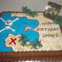 Pirate Birthday Cake Water is made with blue icing and sand look is made with nilla wafers. Skull is made with fondant and drew on with black ediable marker.