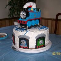 Thomas And Friends Cake I did the train faces in the tunnels all in fondant, along with the tracks on top and the Happy Birthday. I baked 3 12" pans of cake....