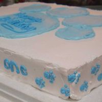 Blue's Clues Cake I only used a #2 piping tip to do the wording and the little paw prints. To make the large paw print on top, I drew it out with a toothpick...