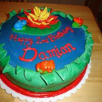 My First Fondant Cake- Lily Pad Frog Pond!! for my sons birthday~ rolled fondant, pre-made, bottom layer triple chocolate fugde, top layer white cake, with blue food coloring to make...