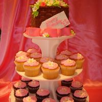Cupcakes And Spring Basket This was for my Mom's club. She wanted a basket of flowers on top and I was inspired by susgene's beautiful flower basket cake....