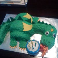 Dragon Birthday Cake This was my first time doing a sculpted cake. The dragon's "fire" is supposed to be lighting the candles on the mini-...