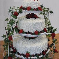 Fresh Fruit French vanilla cake with vanilla mousse and fresh strawberry filling. Buttercream and fresh fruit decorations. Bride provided a picture - I...