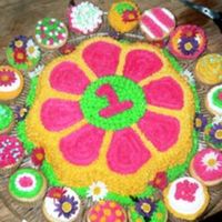 Gianna's 1St Bday Flower cake using Wilton mold. Cupcakes surrounding.