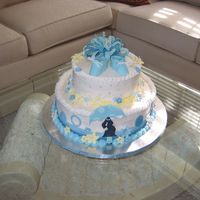 Mod Mom Boy Buttercream frosting with royal icing flowers. Fondant bow and booties.