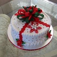 Christmas Cake Buttercream frosting with fondant bow and accents. Royal icing poinsettias.