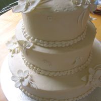 Wedding Cake - Simple Cream Color With Gumpaste Flowers A very lovely young bride I work with requested this one. Buttercream with sugarpaste flowers. Thanks for looking!