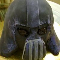 Darth Vader Sculpted Darth Vader cake covered in fondant. The eyes are done with piping gel. I must say, he scares me a little bit, but that's...