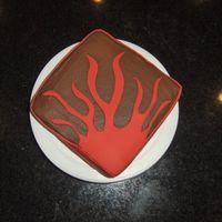 Red Flame choc. icing, with red fondant sides and flames.