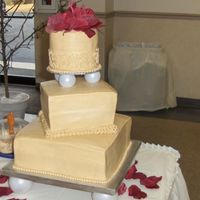 Brides Cake 12" sq on bottom, 8" sq in middle, 6" round on top. Burg. silk rose pettals on top. Free handed the scroll work. Golden...