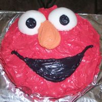 Elmo Birthday Cake Chocolate cake with whipped cream frosting and fondant eyes.