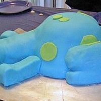 Blue 3D Dinosaur A carved 3D dinosaur with fondant frosting. Green dots and eyes also in fondant