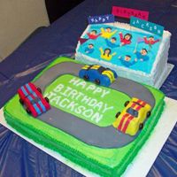 Race Track And Stands 9x13 race track with buttercream and fondant track. 3D carved cars with fndant icing. Stand was carved from a sheet cake with royal icing...