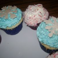 Christmas Cupcakes snowflakes are made out of white chocolate that I free hand piped and painted with luster dust. The red and white ones are red velvet with...