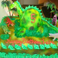 Dino Cake This cake was fun to make. Little 5 year old boy loved dinosaurs. 1/2 sheet chocolate cake with a fondant covered wilton doll cake pan....