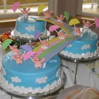 Diaper Downpour My first baby shower cake... all fondant, even the babies and umbrellas. the pins and bottles are plastic.