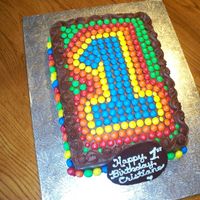M & M's Themed 1St Birthday Cake Colourful cake made for an M&M themed first birthday party. Used mini, peanut and regular M&M's.