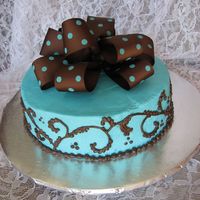 Turqoise Polka Dots Yellow cake soaked w/ Grand Marnier and iced w/ buttercream. My first try at a fabric bow. I don't quite have it down yet.
