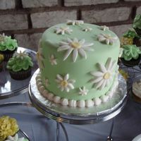 Small Cake For Bride And Groom I did 125 cupcakes to go with this cake. it was for an outdoor casual wedding. Fondant with fondant daisies.