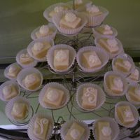 My First Petit Fours White chocolate ganache over yellow cake and buttercream rosettes. Thanks to LisaMS for her recipe!
