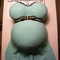 First Pregnant Belly Cake Yellow cake made with soccer ball pan for belly and mini wonder mold for breasts. Colors for the shower were turquoise, chocolate, and a &#...