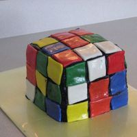 Rubik's Cube My daughter had an 80's theme bday party so I made her a Rubiks cube. The fondant squares started to slide a little in the heat. I...
