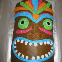 Tiki Man For Luau Themed House Warming Party The cake is made from 4 small oval cakes cut in half and stacked. It is decorated in Buttercream Icing.