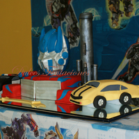 Transformer This I made with a 9 x 13" sheet pan cake x 4" high for the body . Then I made anoter 9 x 13" and cut in half and carved the...