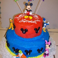 Mickey Mouse 1St Birthday Cake All Buttercream frosting with Disney figurines and star candles.