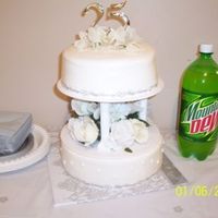 25Th Anniversary Cake My very first *big* cake. Was made for my inlaws 25th anniversary. Dark chocolate scratch cake on top & yellow cake w/ extender on...