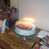 Lightning Mcqueen Cars Cake Second shot of cake with candles. "Happy Birthday Brandon" was piped around the side of the cake which I had frosted with a &quot...