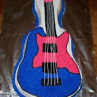 Guitar Hero 80S Cake This was made for a Guitar Hero 80s party I had. I decorated it justhours before the party! Yellow cake, with BC icing. I needed to thinout...