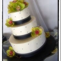 Elizabeth Ivory buttercream, black fondant dots and satin ribbon. Orchids are real. Didn't have the time to make them, I also wasn't in the...