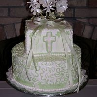 Baptism Cake 2 Tier Baptism cake. White Buttercream icing with green accents. Cross and daisy's around border were done from fondant and dusted...