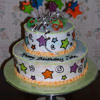 Cosmic Stars Birthday Cake Two tier cake, buttercream icing marbled with different neon colors. Fondant stars on top. Tinted piping gel for designs on sides of cake...
