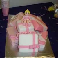 Presents For Baby chocolate cake with chocolate/coconut filling and fondant on top. gumpaste figurine on top.
