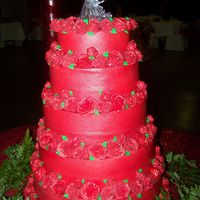 Red Rose Wedding Cake 5 Tier Red wedding cake decorated with lots of roses around each layer.