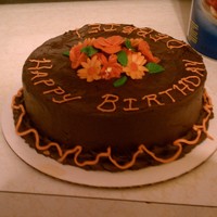 Fall Birthday Chocolate cake with chocolate frosting filled with Orange buttercream. Flowers are fondant.